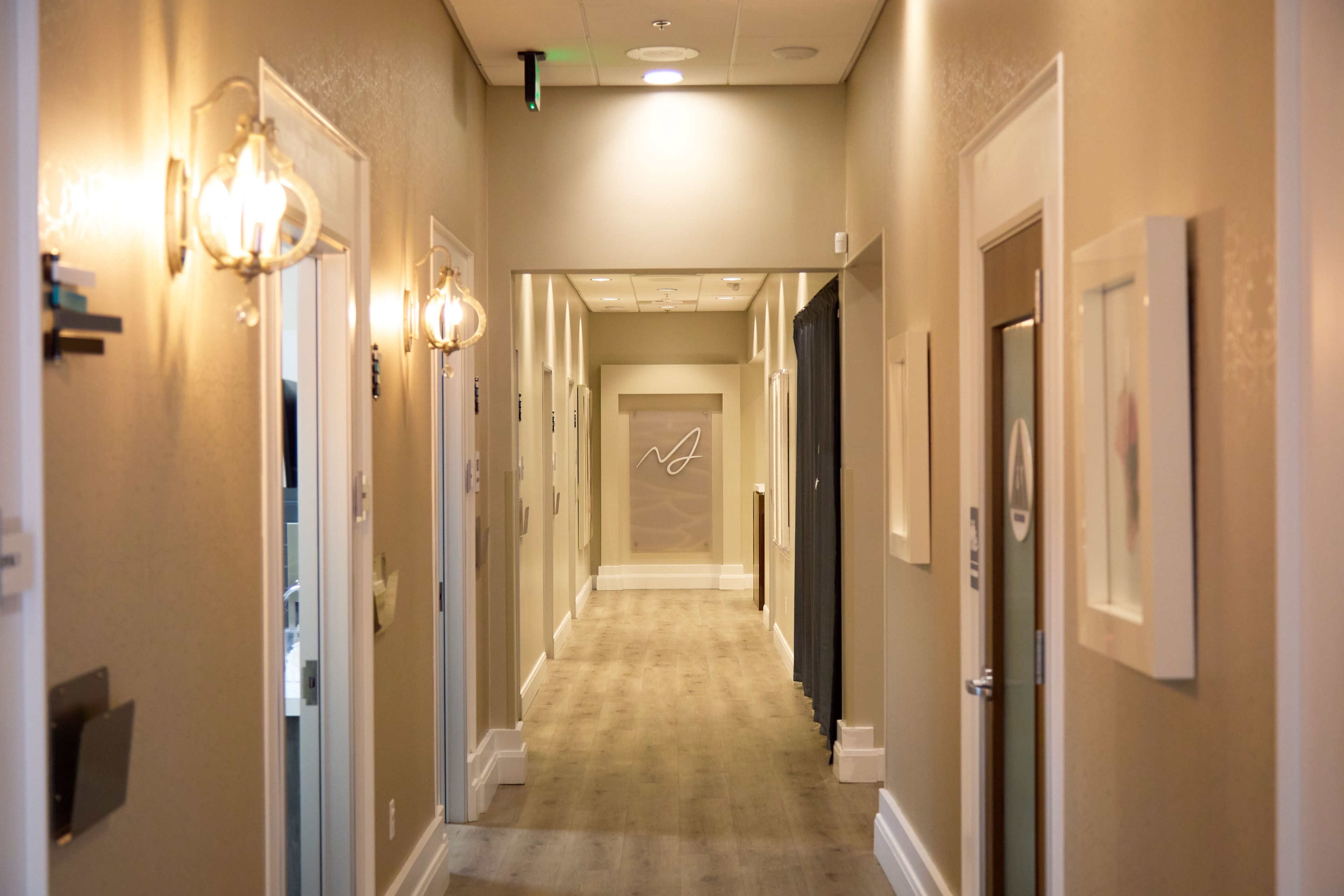 The clinic hallway leading to the etched wordmark