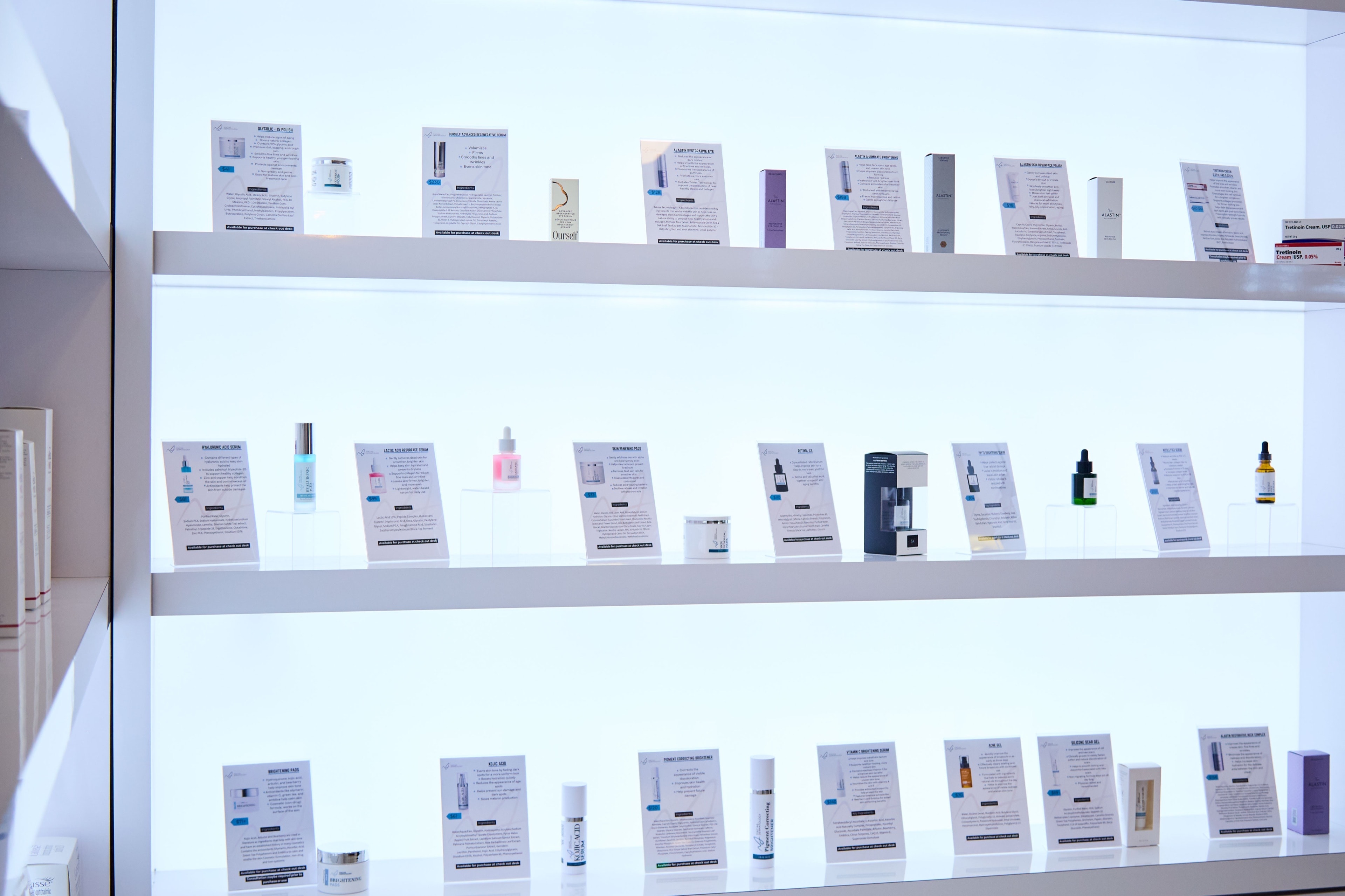 The backlit skincare wall in the cosmetic wing