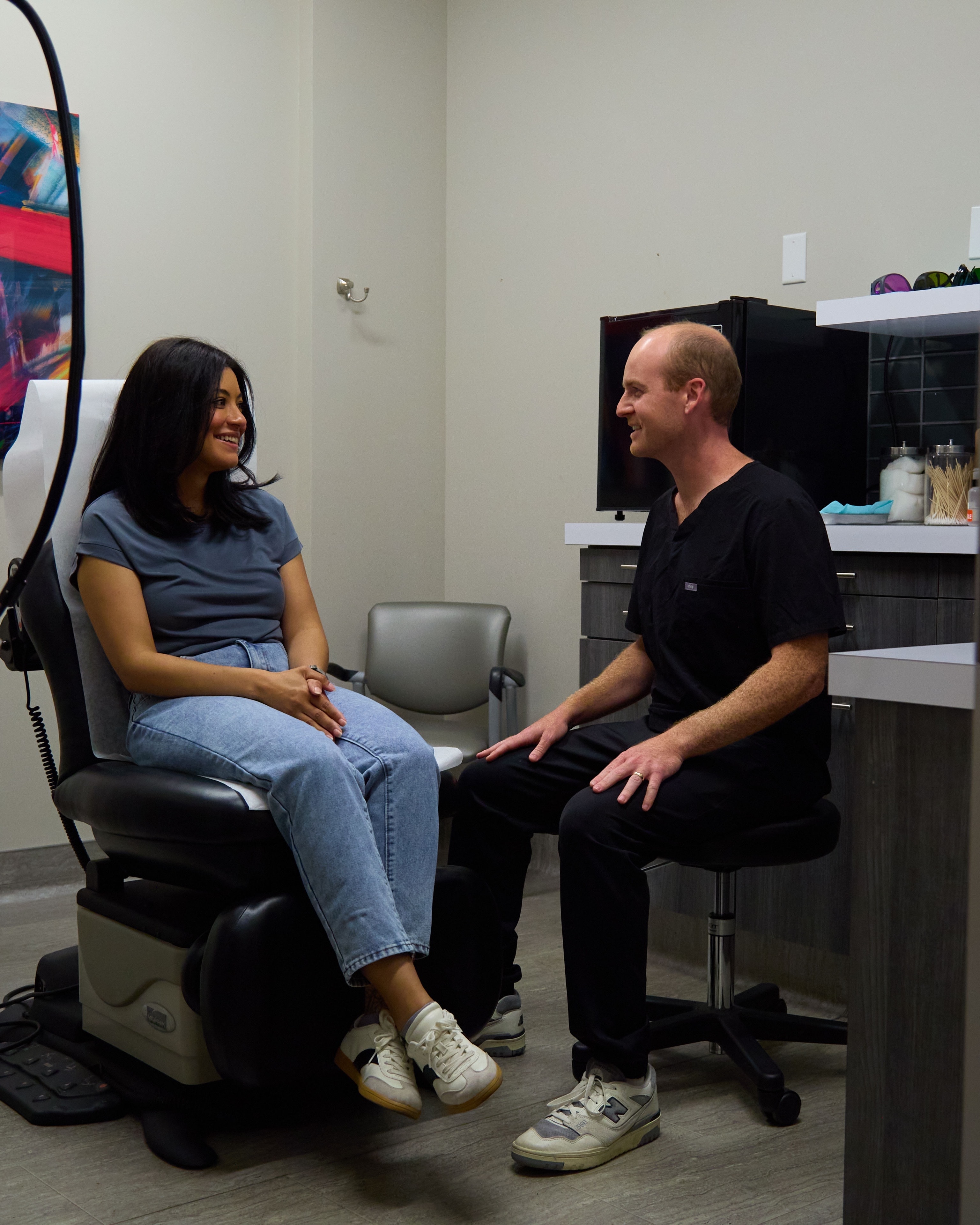 A Macias Dermatology clinician in unhurried conversation with a patient