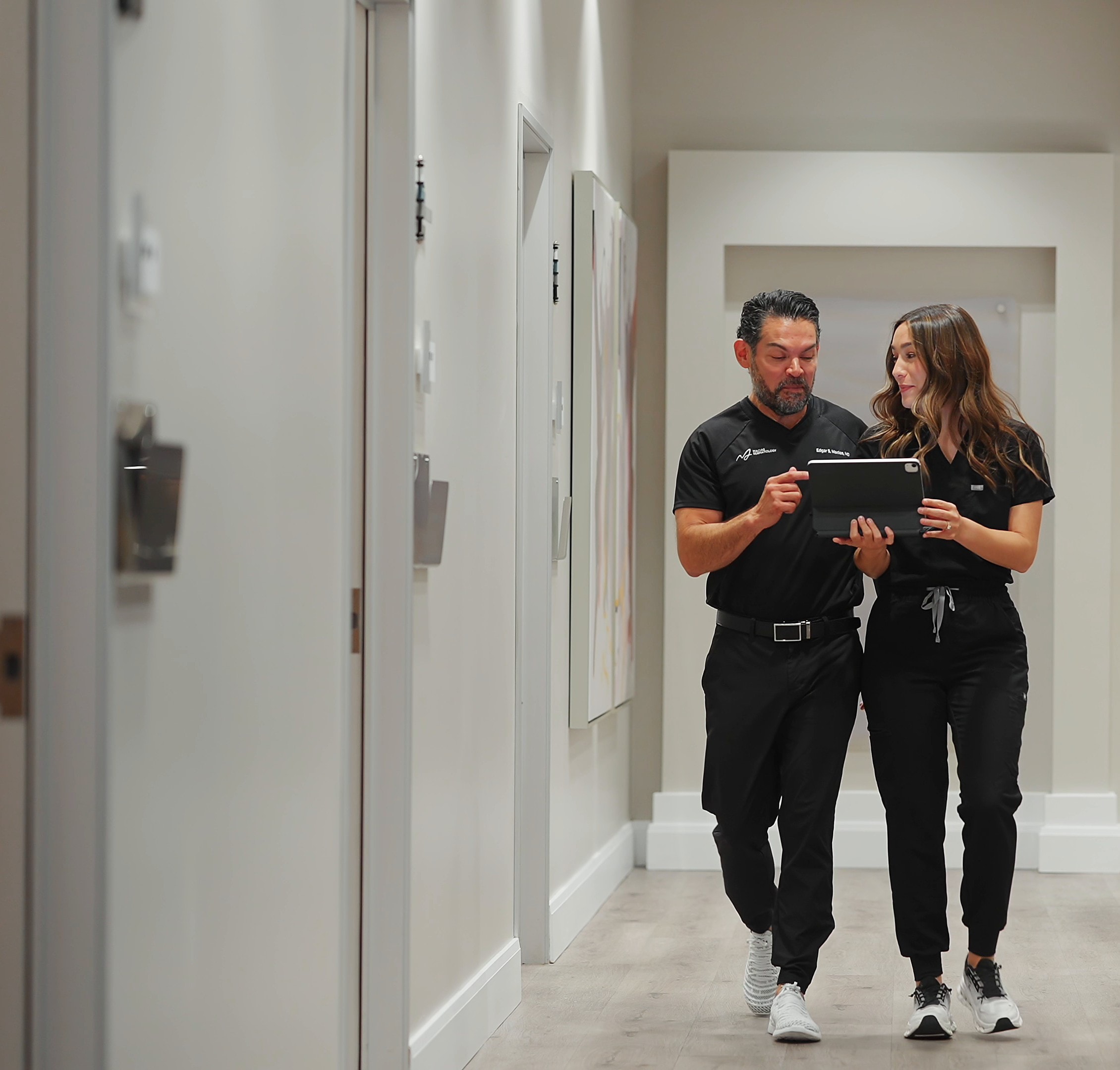 Dr. Macias and a team member reviewing notes together in the clinic hallway